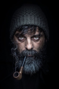 Dramatic Portrait of a Bearded Man with a Pipe