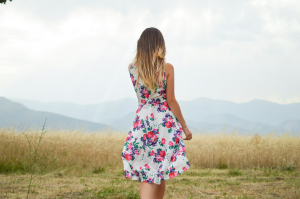 Ethereal Beauty in Floral Dress: A Serene Daytime Field Encounter