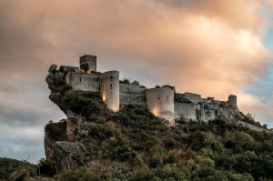Roccascalegna: An Illuminated Fortress Amidst Gray Clouds in Italy