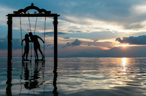 Romantic Sunset: Dancing on a Water Swing