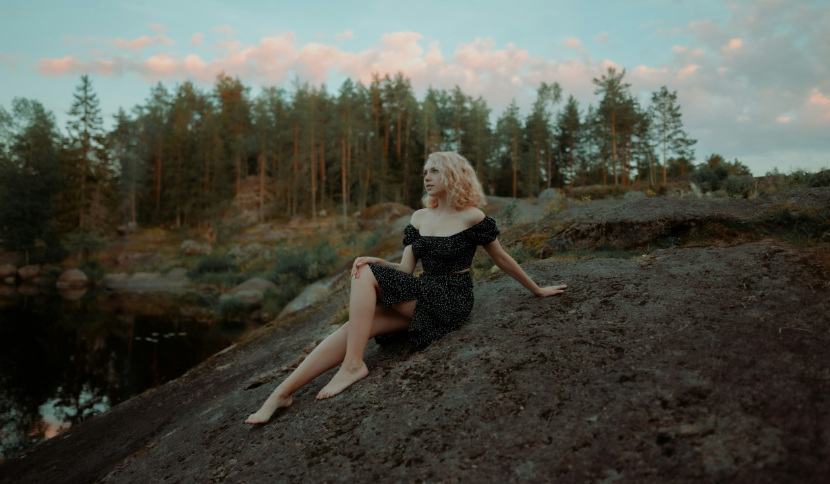 Sunset Solitude: A Person Sitting on a Dirt Path in Vyborg, Leningrad Oblast, Russia